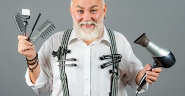 coiffeur pour homme qui utilise un sèche cheveux ionique et des peignes pour la coupe de cheveux