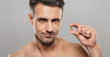 homme qui tient une cellule de complément pour sa chevelure